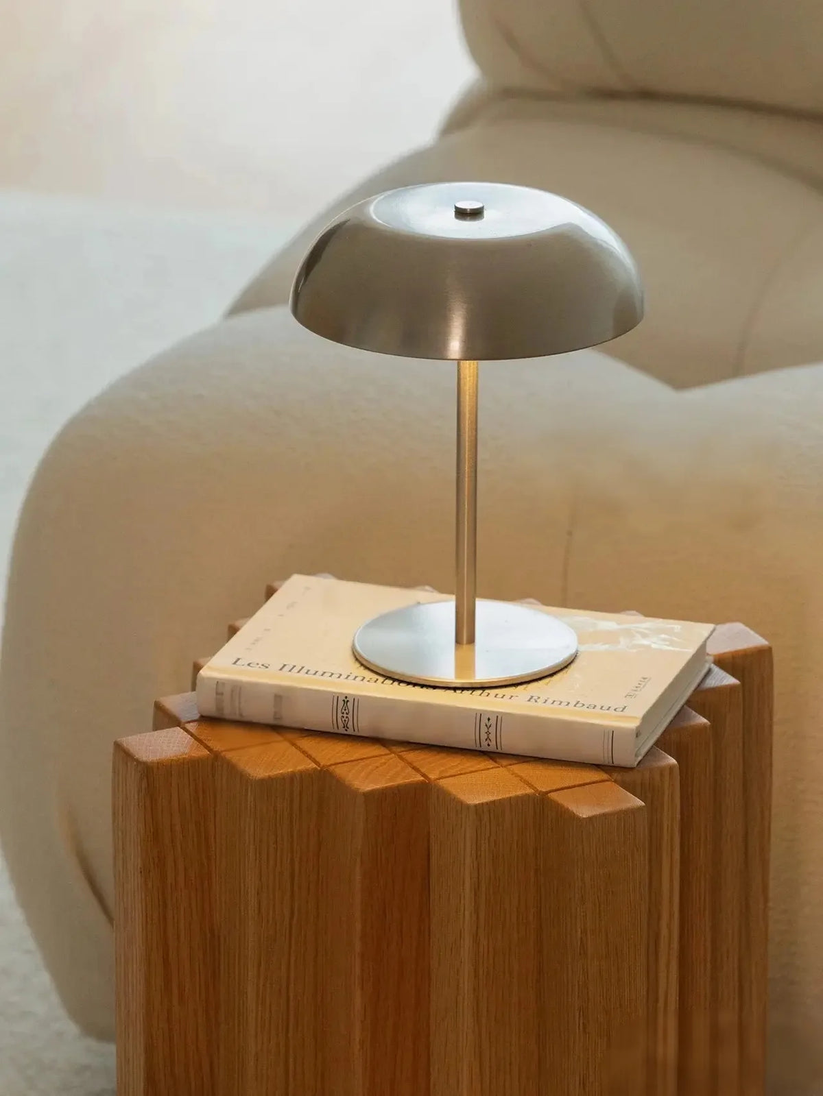 Cordless rechargeable touch table lamp glowing warm on a dining table